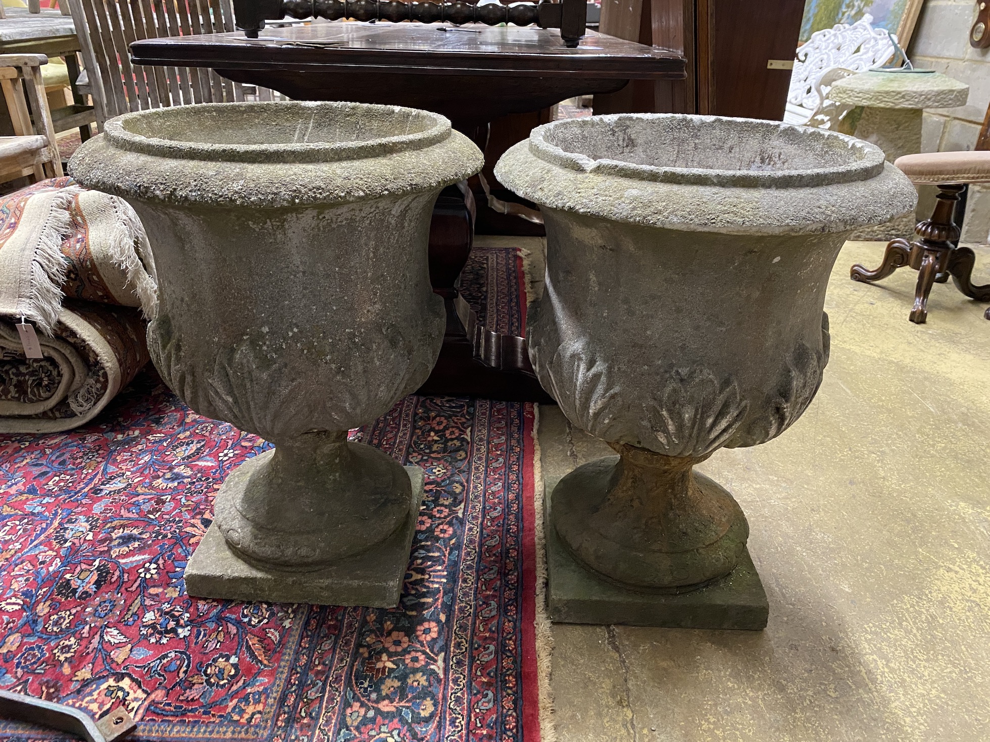 A pair of circular reconstituted stone garden planters, diameter 54cm, height 70cm